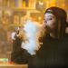 Confused vaping woman  - Stock Image